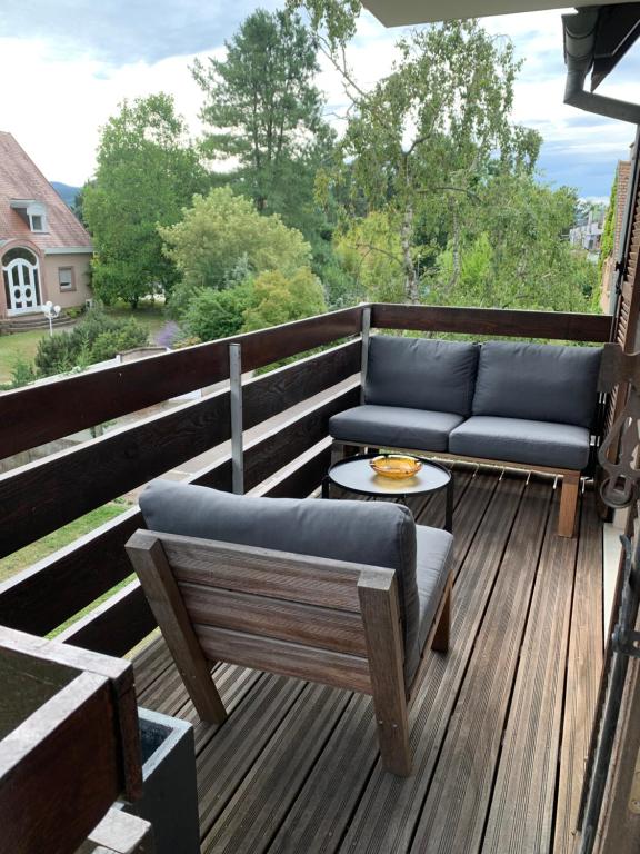 a deck with two couches and a table at Appartement spacieux et lumineux in Sélestat