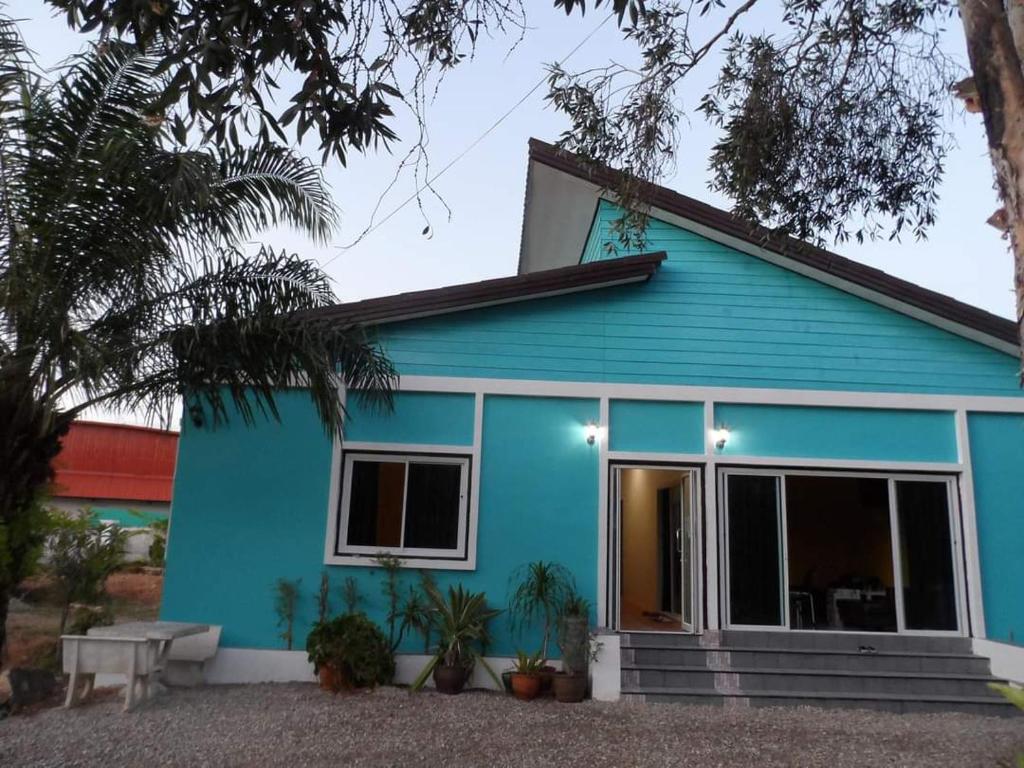 a blue house with a large window at Life&Love Resort in Ban Khlong Son