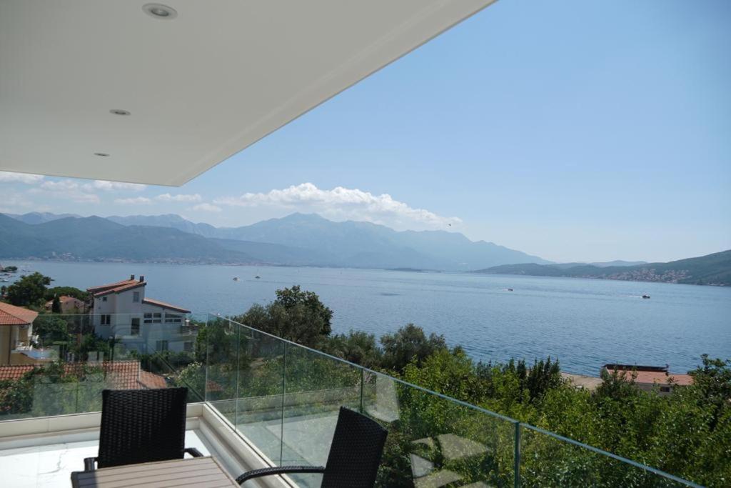 a balcony with a view of a body of water at Villa Le Grand Bleu in Ðenovići