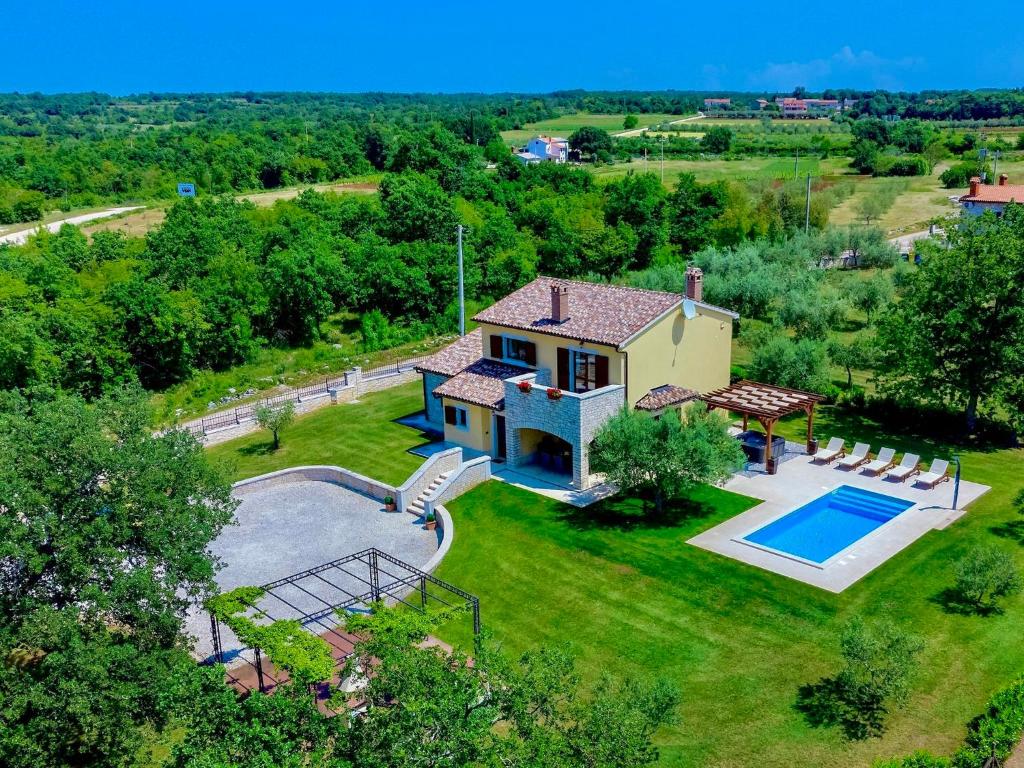 an aerial view of a house with a swimming pool at Villa Blog 1 by Interhome in Vošteni
