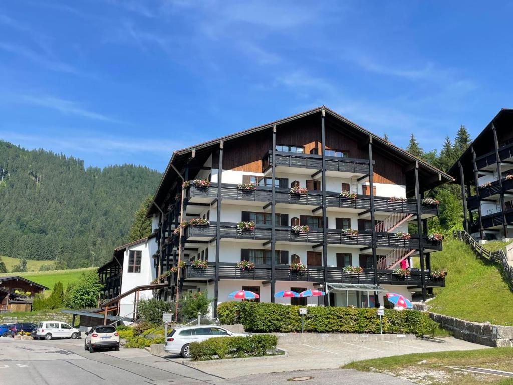 a building with balconies and cars parked in a parking lot at Apartment Buchenhöhe-2 by Interhome in Resten