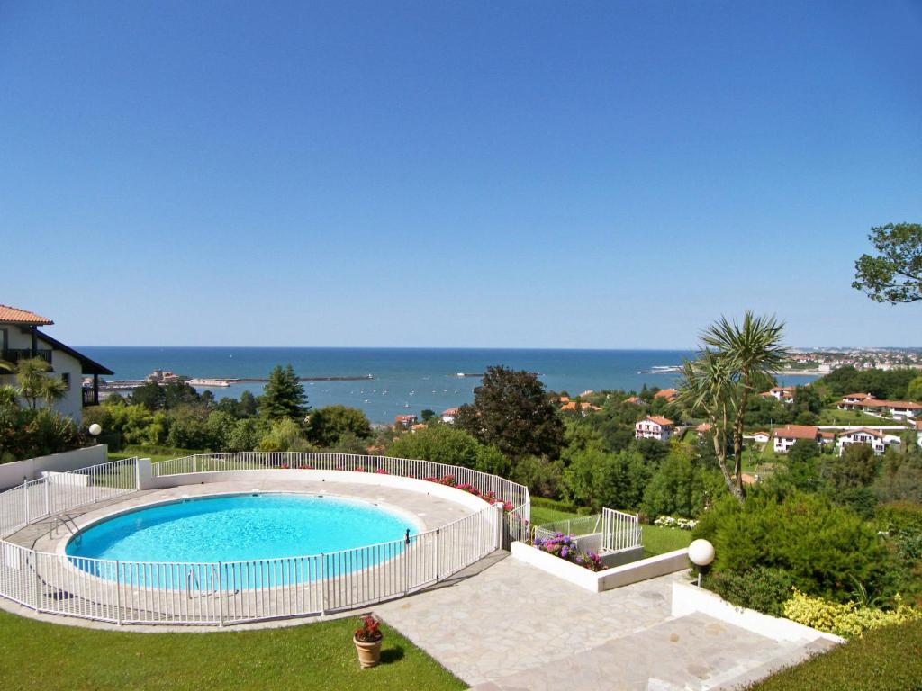 a swimming pool with a view of the ocean at Apartment Les Hauts de Bordagain-13 by Interhome in Ciboure