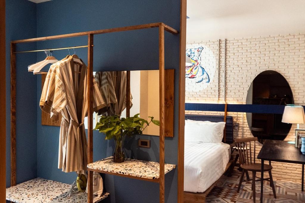 a bedroom with a bunk bed and a blue wall at Tints of Blue Hotel in Bangkok