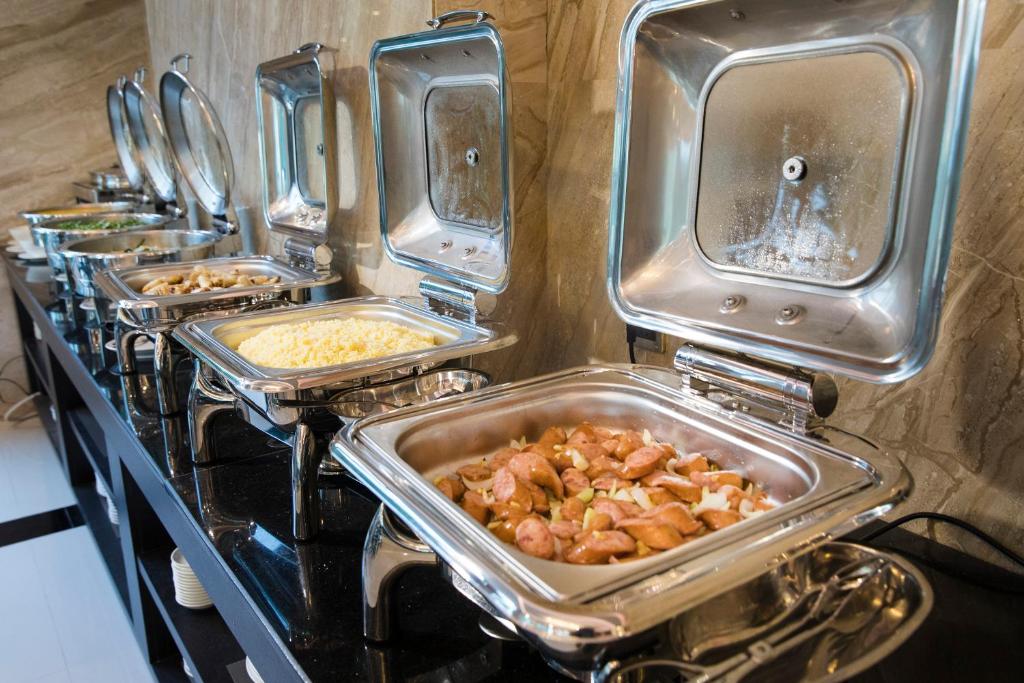 a row of trays of food on a stove at Putin Hotel Nha Trang in Nha Trang