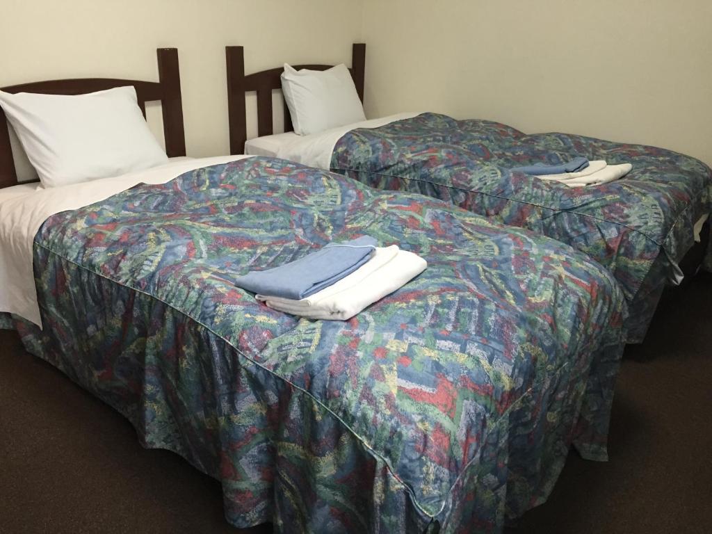 Postel nebo postele na pokoji v ubytování Urban Hotel Morishita