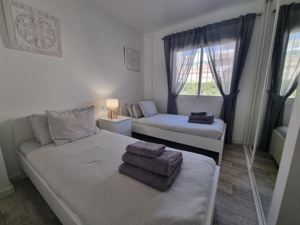 A bed or beds in a room at 3 Bedroom Apartment Playa Flamenca La Zenia