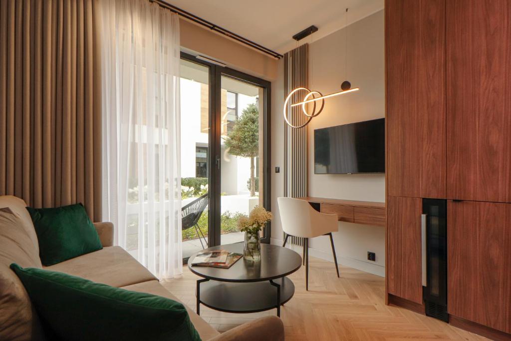 a living room with a couch and a table at Apartament Olimpijska 116 in Olsztyn