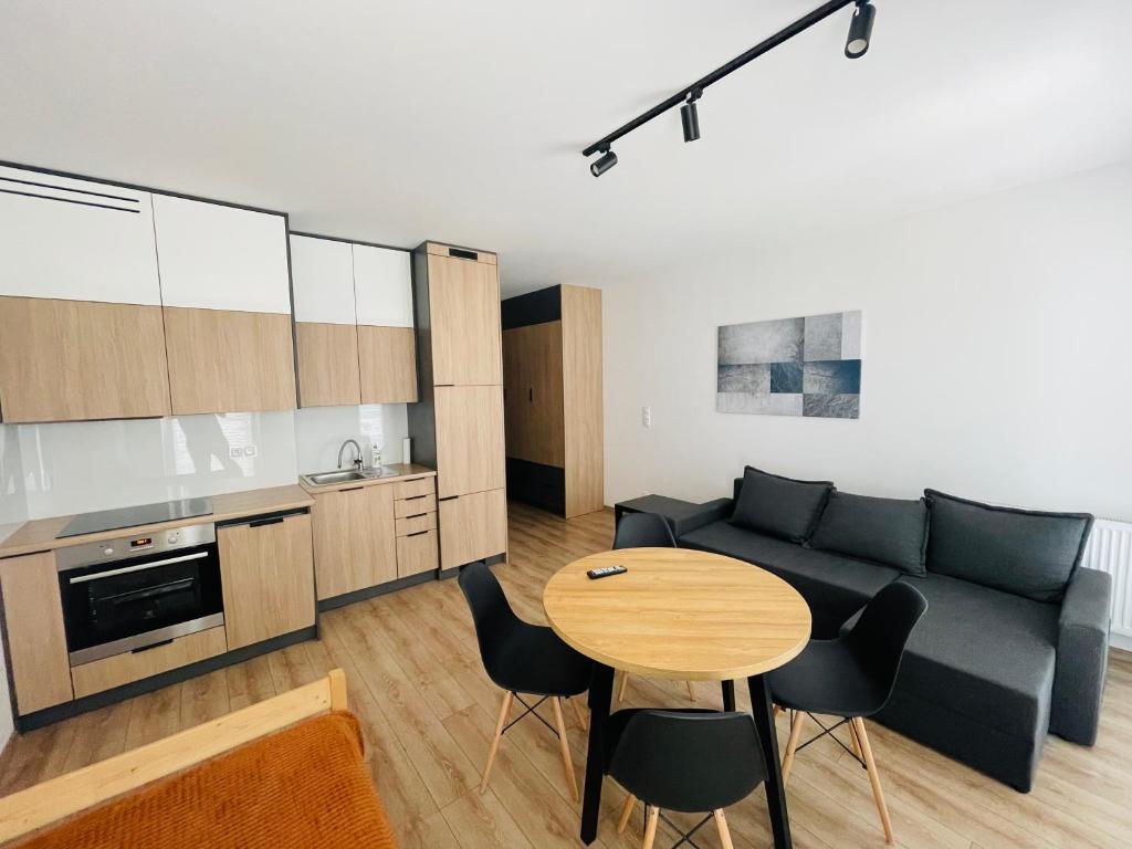 a living room with a couch and a table at Apartament Osiedle Okrzei in Kielce