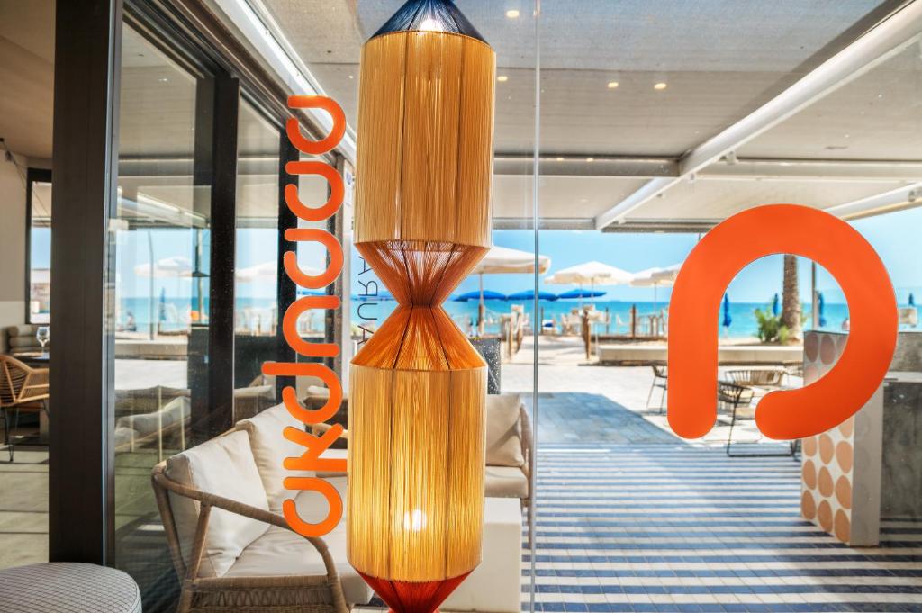 a chandelier in a restaurant with a view of the beach at Akquaaa Boutique Hotel in Calafell