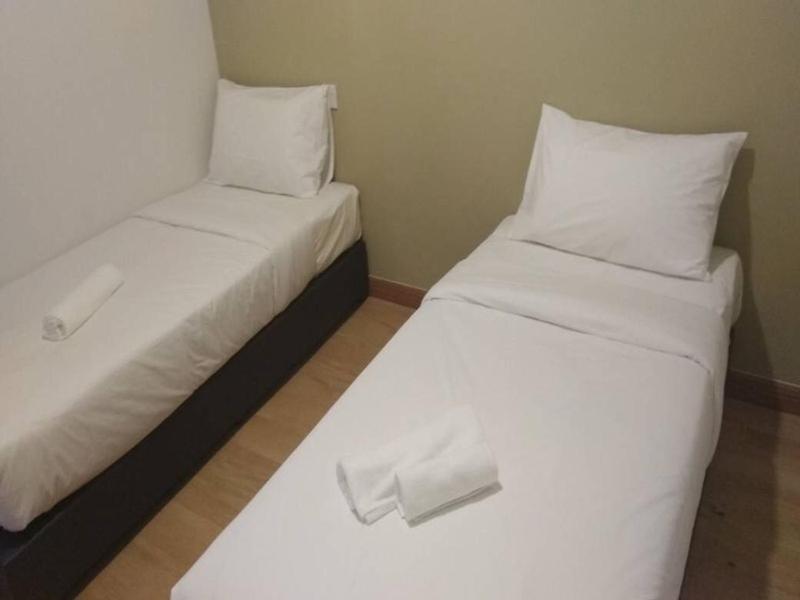 Postel nebo postele na pokoji v ubytování Gem Hotel Nusa Sentral Nusajaya