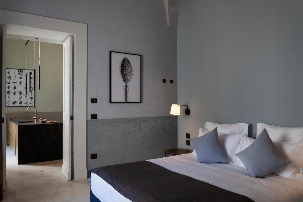 Postel nebo postele na pokoji v ubytování Palazzo Tafuri Boutique Hotel