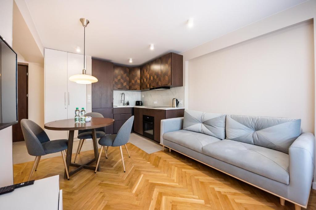 a living room with a couch and a table at Powiśle Chic Apartment in Warsaw