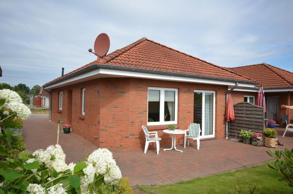 a brick house with a patio with a table and chairs at Buttgereit in Kosel