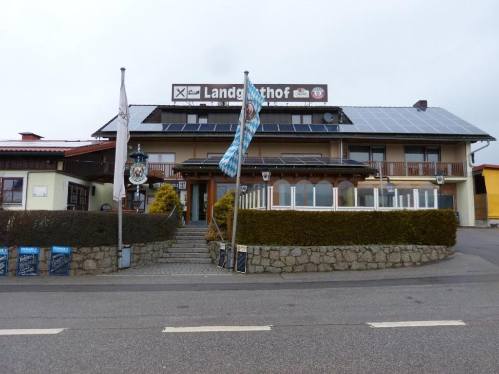 a building with a flag in front of it at Landgasthof Schmidbauer in Nittenau