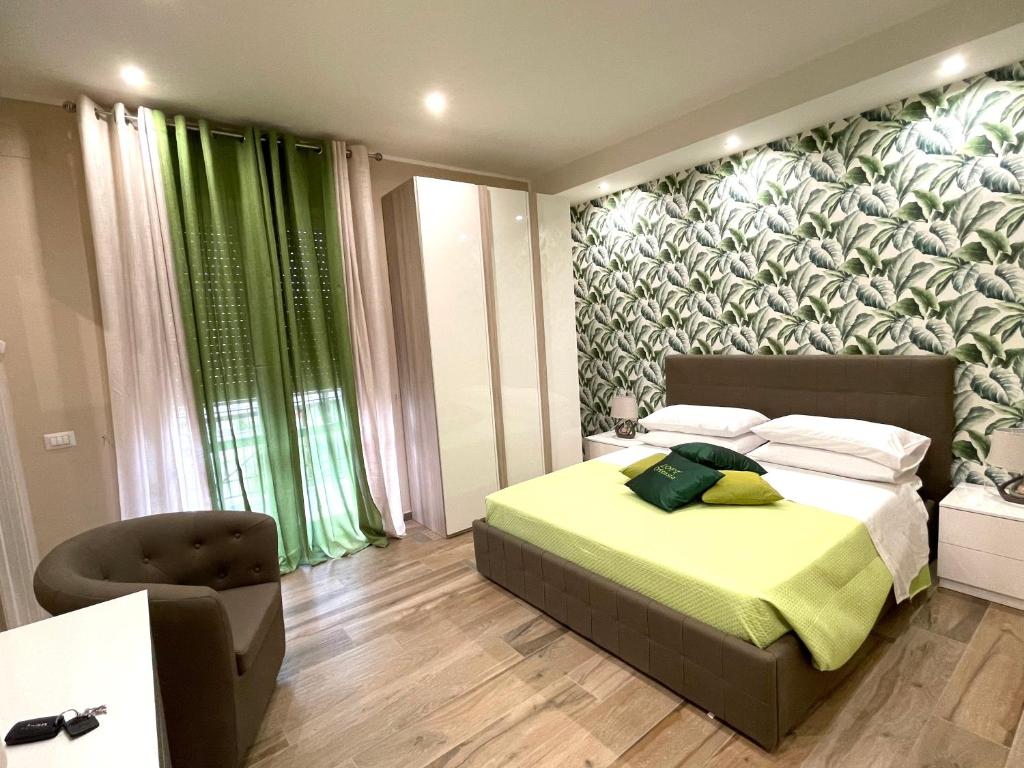 a bedroom with a bed and a green wall at LOFT ORTENSIA in Pompei