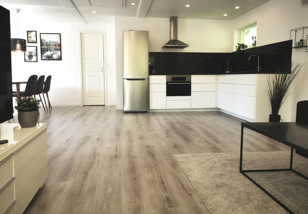 a large kitchen with white and black appliances at Landvetter Apartment in Landvetter