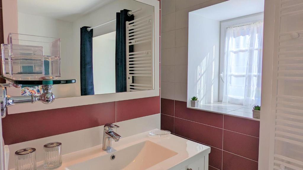 a bathroom with a sink and a mirror at Le petit Moulin de la Motte in Bellenot-sous-Pouilly