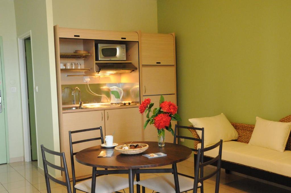a living room with a table and a couch at Hotel Maharajah in Mamoudzou