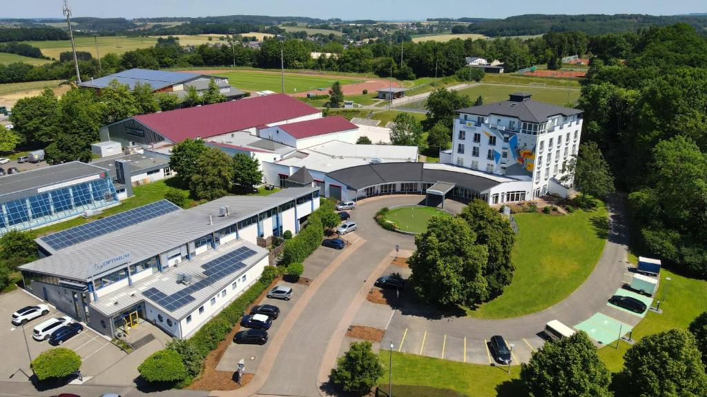 an aerial view of a building with a parking lot at Sport- & Seminarhotel Glockenspitze in Altenkirchen