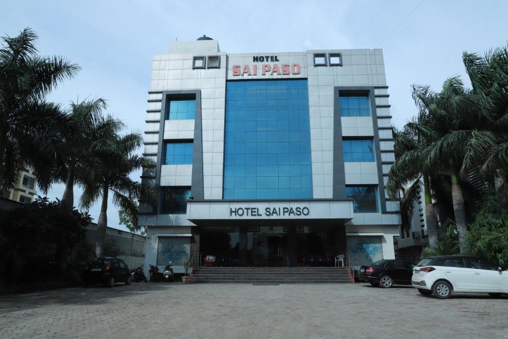 a large building with cars parked in front of it at HOTEL SAI PASO in Shirdi