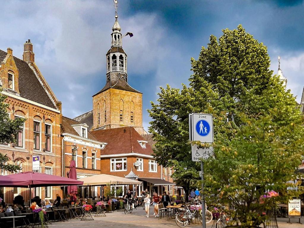 a building with a clock tower in a city at Cosy apartment in the centre of fortified town Groenlo in Groenlo