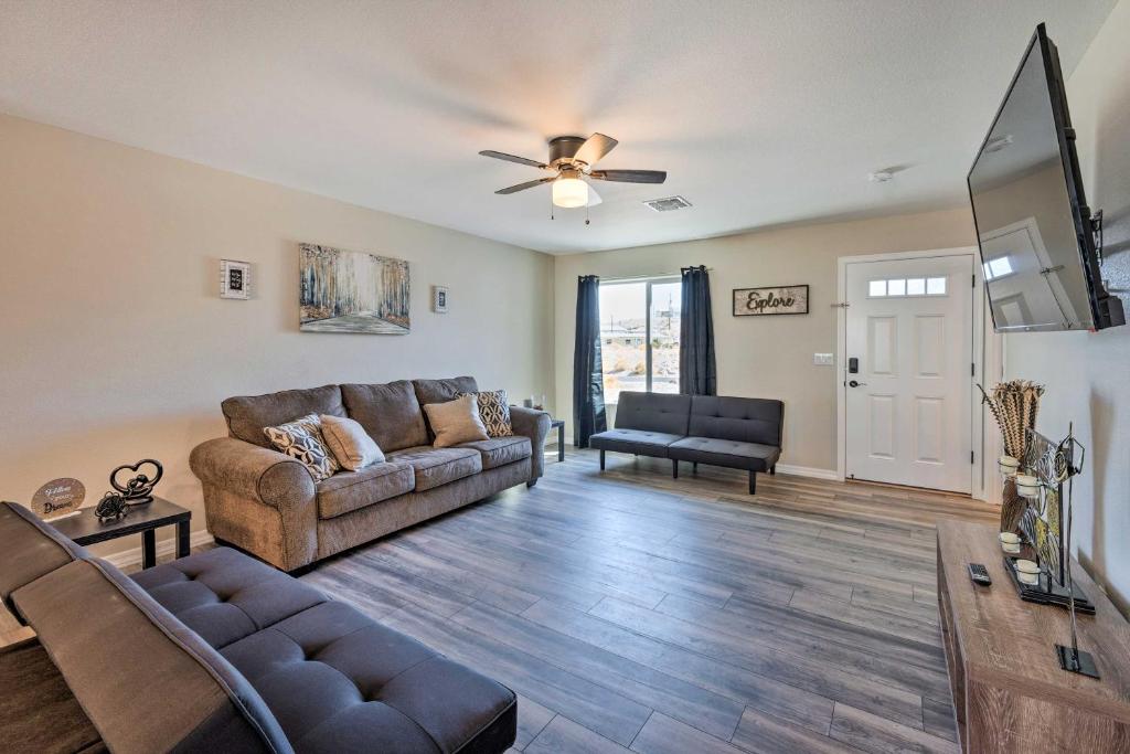a living room with a couch and a ceiling fan at Pet-Friendly Bullhead City Abode with Game Room in Bullhead City