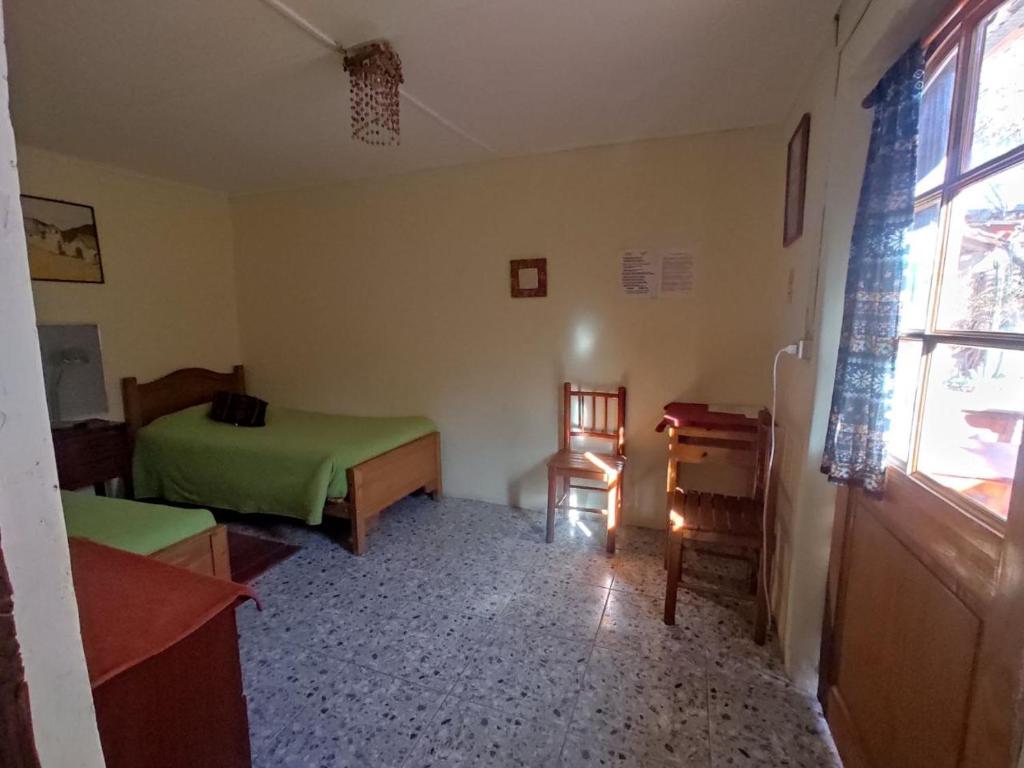 Postel nebo postele na pokoji v ubytování Hostal Sonchek