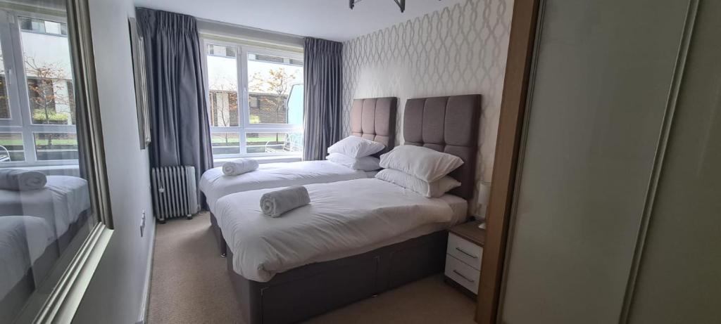 a small bedroom with a bed and a mirror at Empress at College - Spacious 2 bedroom apartment in Southampton