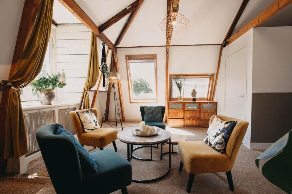 a living room with chairs and a table at Follow your Heart in Amsterdam in Amsterdam