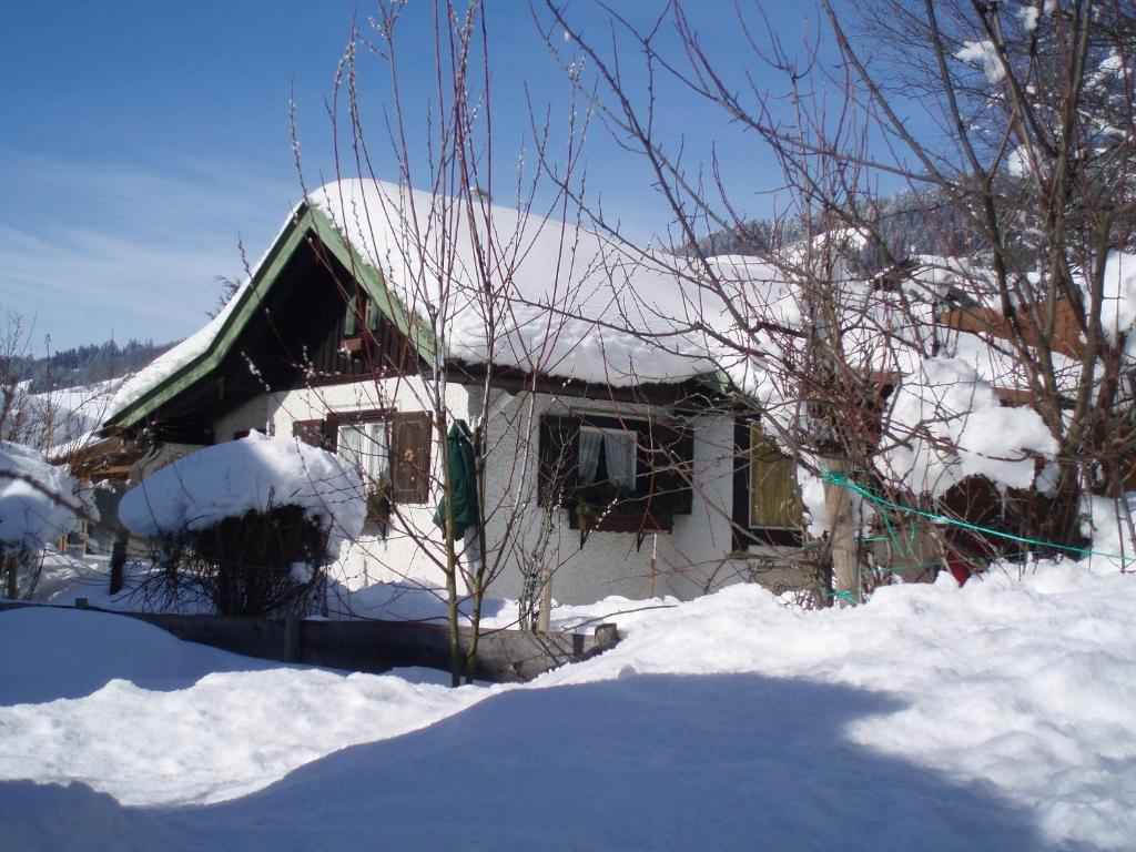 een huis is bedekt met sneeuw bij Haus Deidl in Bad Hindelang