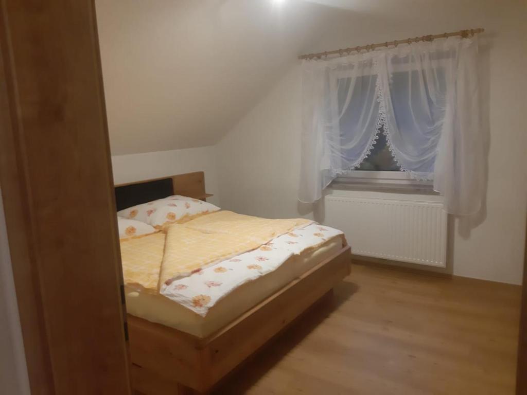 a small bedroom with a bed and a window at Ferienwohnung Anika in Kleinlobming