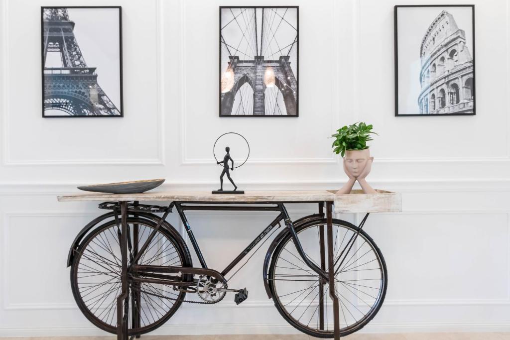 a bike on a table in a room with pictures at Corvinus Smart Apartment with Beautiful View in Budapest