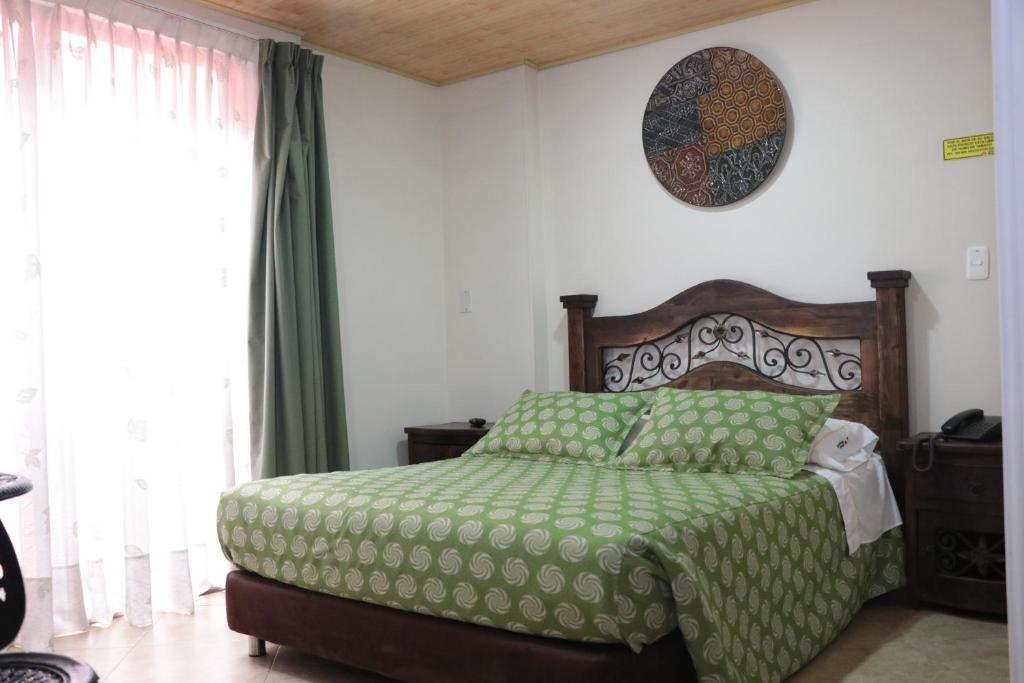 Postel nebo postele na pokoji v ubytování Hoteles Bogotá Inn La Soledad