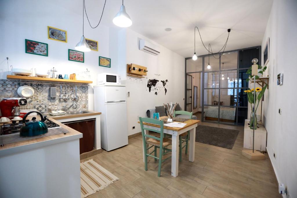 a kitchen with a table and a dining room at La Casetta delle Scienze in Palermo