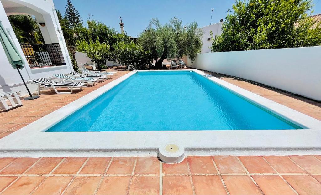 a swimming pool in front of a white wall at CASA EL PARAISO in Coín