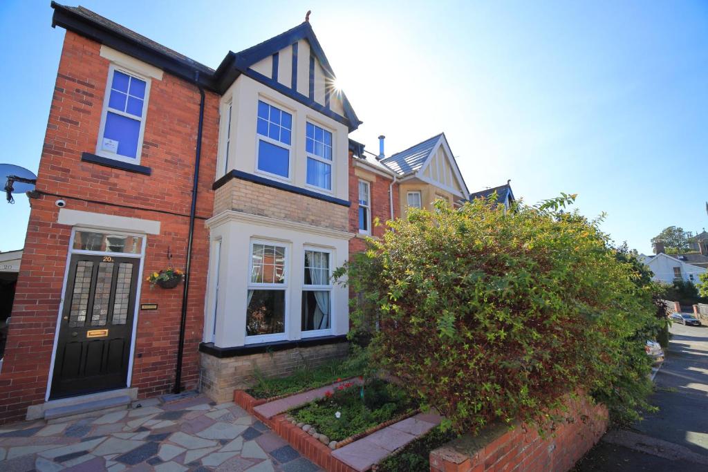 a red brick house with a black door at Exmouth - Newly available, near the Beach in Exmouth