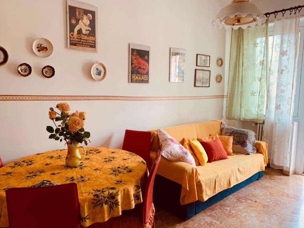 a living room with a couch and a table at Casa Viola in Diano Marina