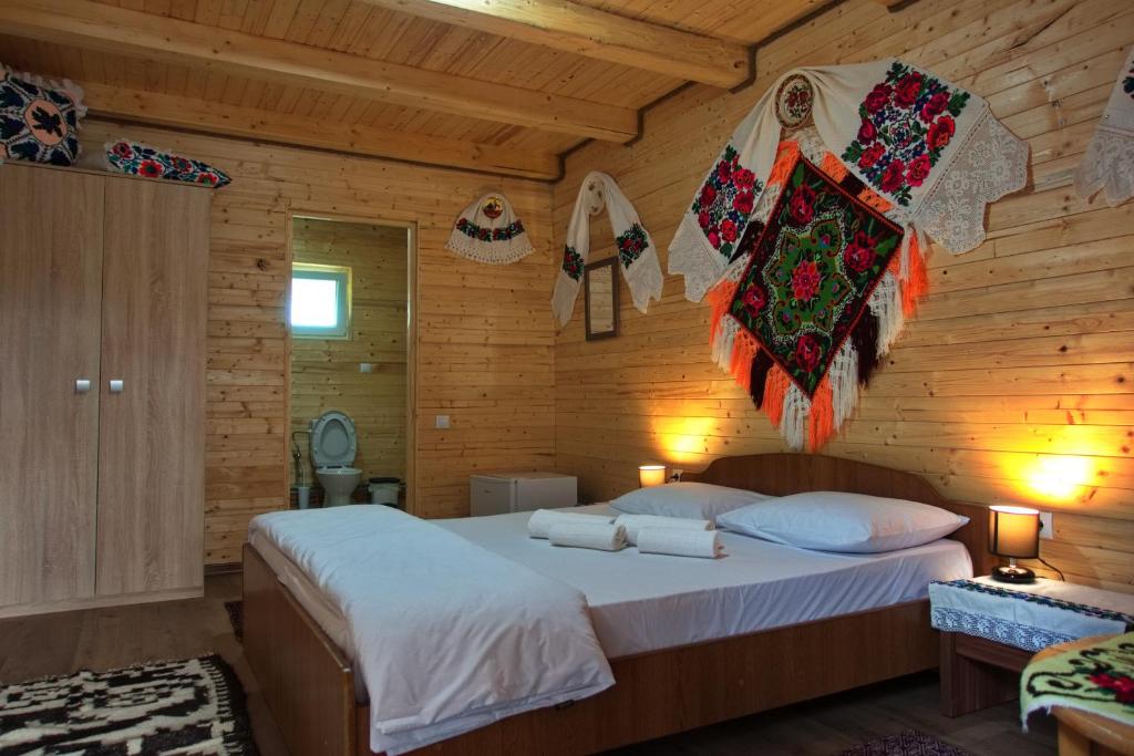 a bedroom with a bed in a wooden room at Breb Casa Luca in Breb