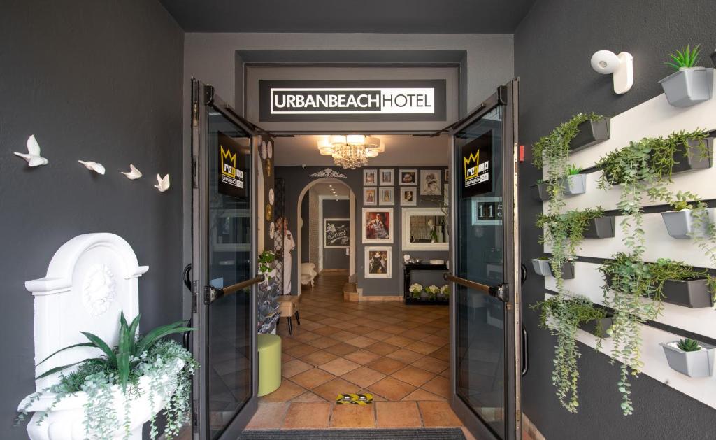 an open door to a room with plants on the walls at Regina Urban Beach Hotel in Lido di Jesolo