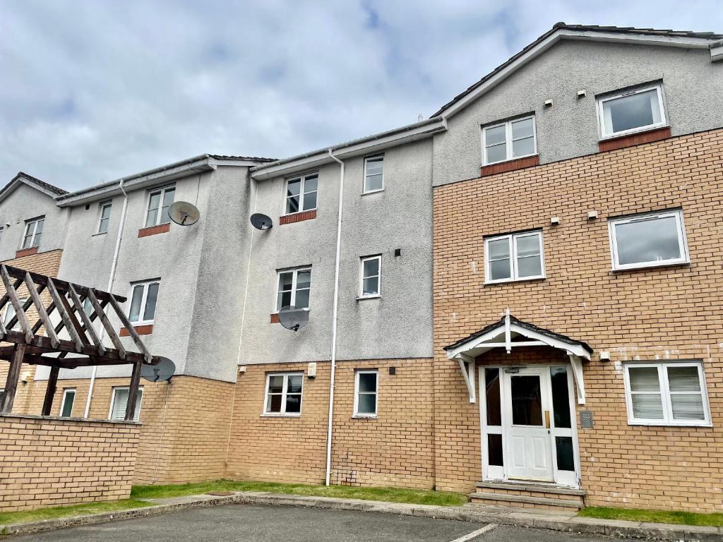 a large brick building with aocracist at Modern 2 bedroom apartment near Glasgow Airport in Paisley