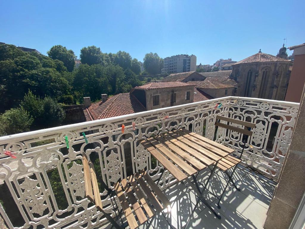 a wooden bench sitting on top of a balcony at PENSIÓN SANTA CLARA in Pontevedra