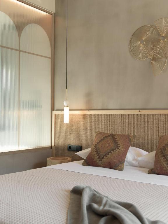 Posteľ alebo postele v izbe v ubytovaní NERĒA Boutique Hotel