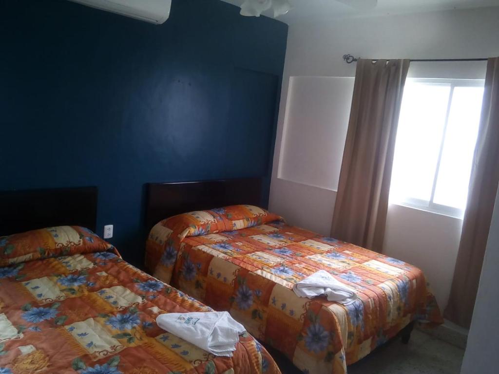 Postel nebo postele na pokoji v ubytování HOTEL ACUARIO CATEMACO