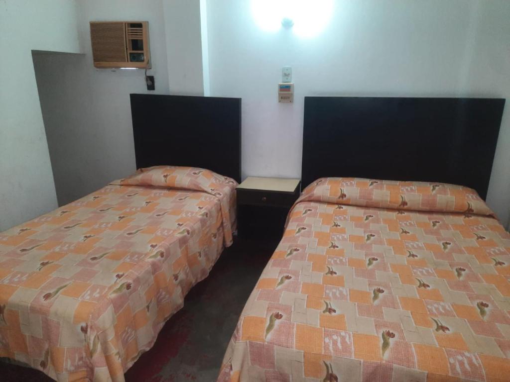 Postel nebo postele na pokoji v ubytování HOTEL ACUARIO CATEMACO