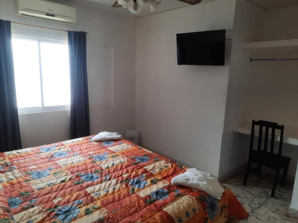 Postel nebo postele na pokoji v ubytování HOTEL ACUARIO CATEMACO