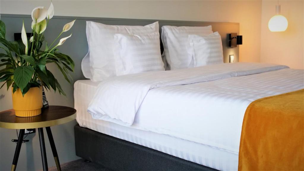 Postel nebo postele na pokoji v ubytování WERK Hotel & SPA