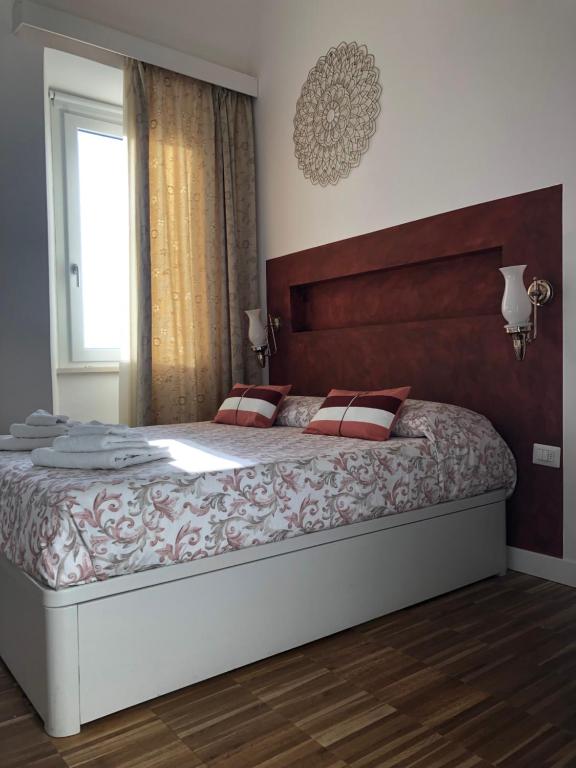 a bedroom with a large bed and a window at B&B Dimor'à in Pitigliano