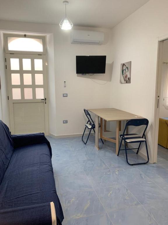 a living room with a couch and a table at NERONE HOUSE in Diamante