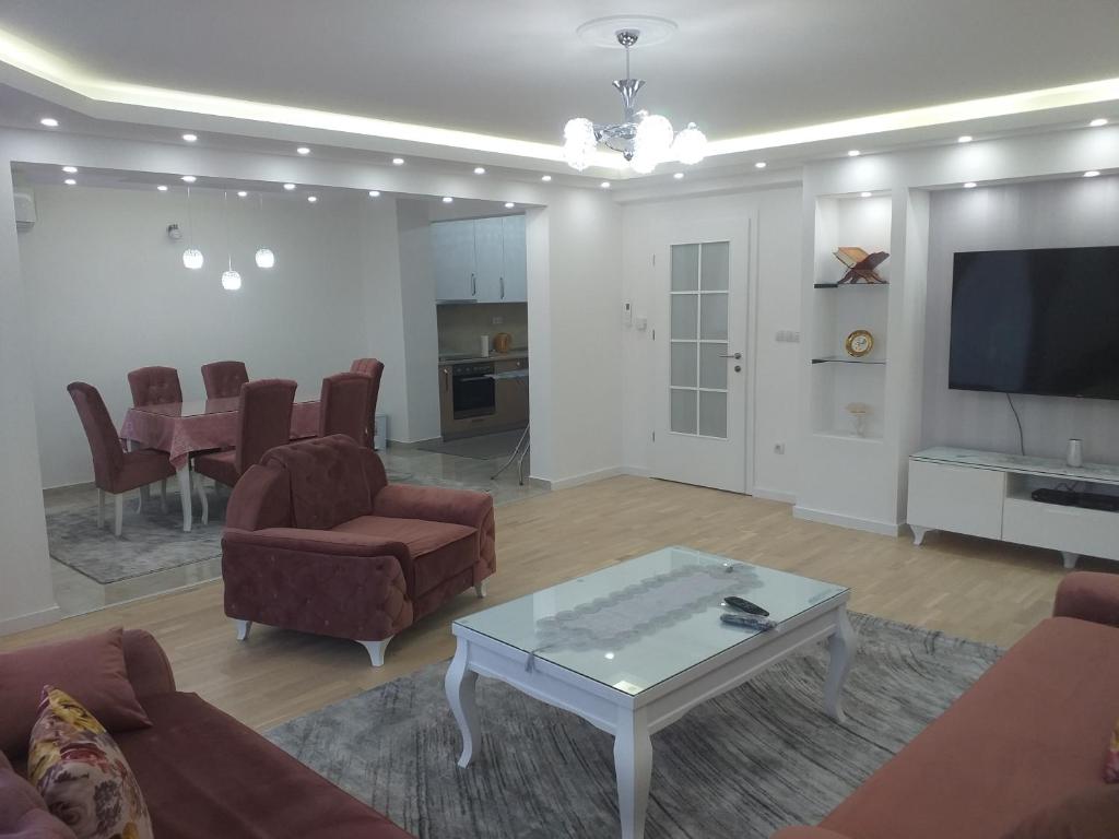 a living room with a couch and a table and a tv at Apartment Ilidza-SK in Sarajevo