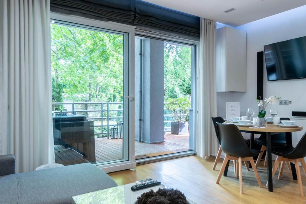 a living room with a table and a large window at Green Spot in Poznań
